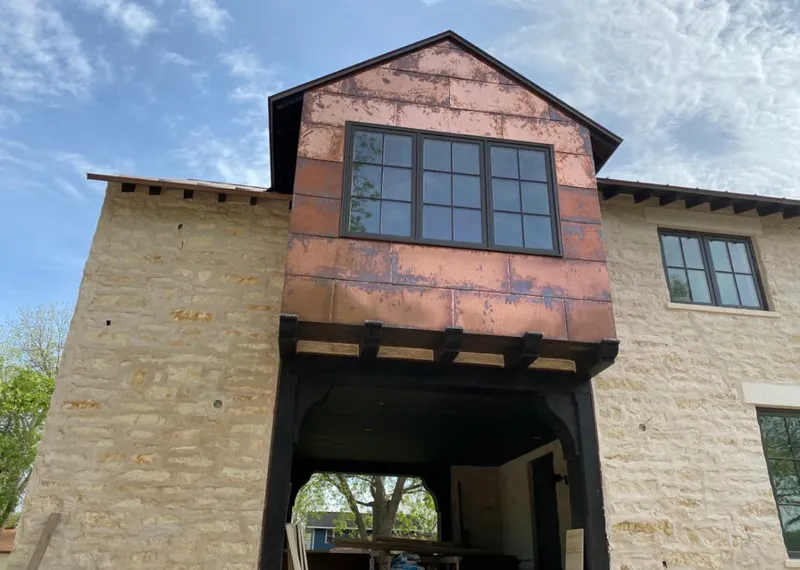Copper metal panel facade on a stone building for Skylight Installation in Springdale