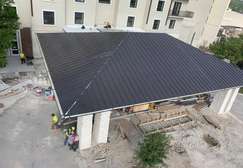 Metal roofing installation team working on a commercial building in Springdale